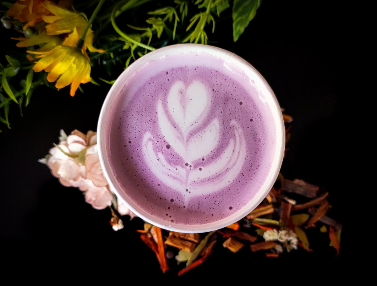 A purple ube latte with heart latte art
